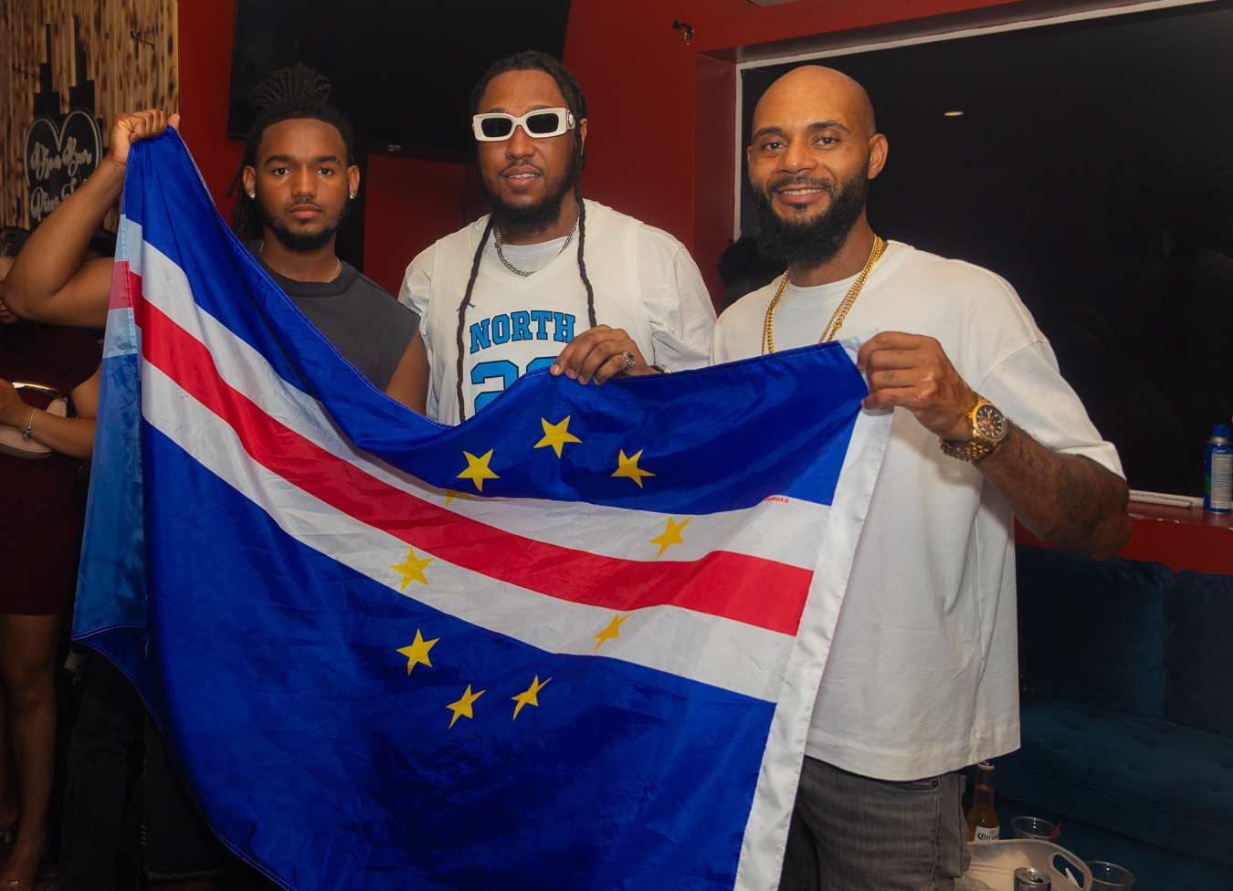 Three men holding a Cape Verde flag